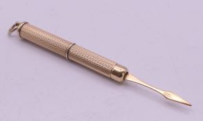 A 9 ct gold hallmarked retractable toothpick. 5.7 grammes. 5 cm closed, 7.5 cm open.