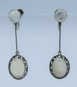 A pair of silver and moonstone earrings. 4.25 cm high.