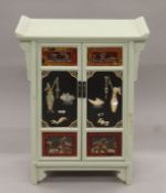 A Chinese lacquered painted and hardstone-set side cabinet. 62.5 cm wide x 81.5 cm high.