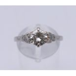 A platinum and diamond ring. The central stone spreading to approximately 1ct. Ring size R.