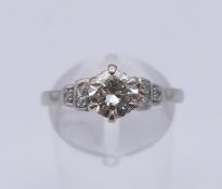A platinum and diamond ring. The central stone spreading to approximately 1ct. Ring size R.