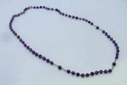 An amethyst bead necklace. 76 cm long.