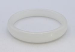A white jade bangle. 1.25 cm high, 0.75 cm deep, 6.25 cm internal diameter.
