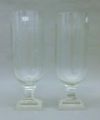 A pair of cut glass storm lamps. Each 34 cm high.