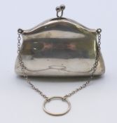 A silver purse. 8 cm x 10 cm. 72 grammes total weight.