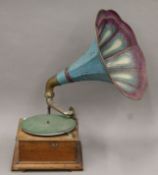 An early 20th century oak-cased gramophone with original blue and purple horn and soundbox.