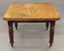 A Victorian mahogany single-leaf extending dining table.
