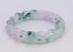 A two-tone jade twist bangle. 1.5 cm high, 6 cm internal diameter.