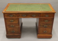 A Victorian walnut pedestal desk with gilt tooled leather inset top. 122 cm wide, 76.