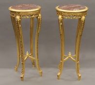 A pair of marble-topped gilt wood stands. Each 110 cm high.