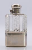 A small silver mounted cut glass hip flask. 9.5 cm high.