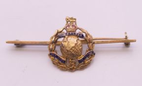 A 9 ct gold Royal Marines 'Gibraltar per mare per terram' brooch, boxed. 5 cm long, 2 cm high. 4.