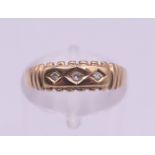 A 9 ct gold three stone diamond ring. Ring size L. 1.3 grammes total weight.