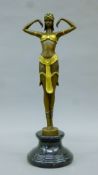 A bronze and gilt model of an Art Deco dancing girl on a plinth base. 41 cm high.