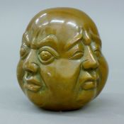 A bronze four-faced Buddha head. 11 cm high.