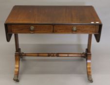A line-inlaid mahogany sofa table. 97 cm wide.