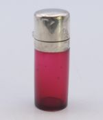 A cranberry glass and silver scent bottle with stopper. 5.5 cm high.