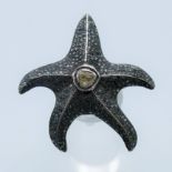 An unmarked silver and diamond star fish ring. Star fish 4 cm high. Ring size N/O.