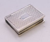 A small Georgian silver book form vinaigrette. 2 cm x 2.5 cm.