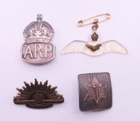 Four WWII military and other badges. The largest 5 cm wide.
