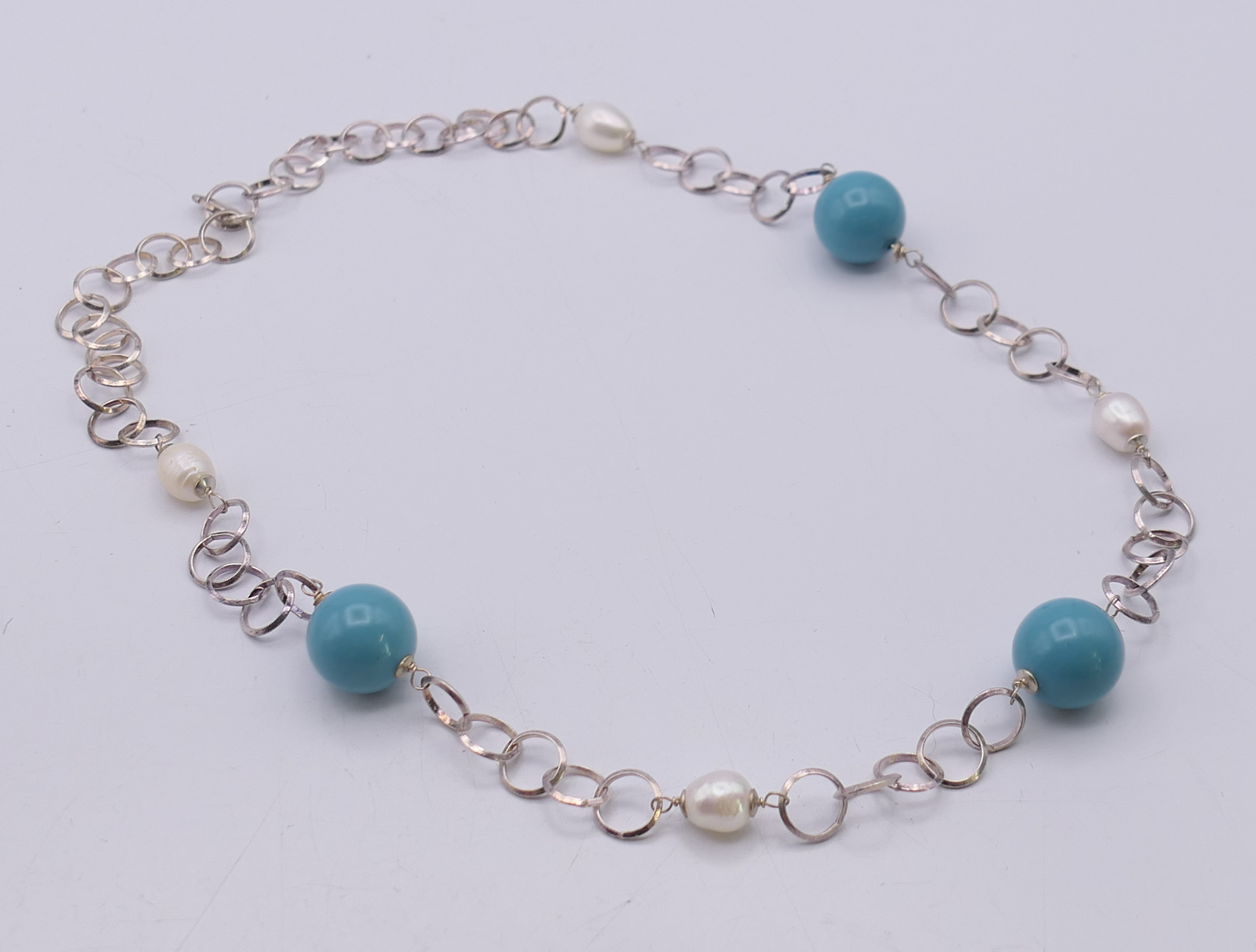 A boxed Christian Lay silver necklace set with pearls and Tiffany blue roundels, with certificate.