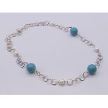 A boxed Christian Lay silver necklace set with pearls and Tiffany blue roundels, with certificate.