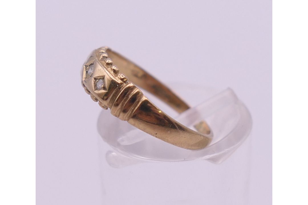 A 9 ct gold three stone diamond ring. Ring size L. 1.3 grammes total weight. - Image 6 of 7