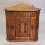 A early 20th century carved oak hanging corner cupboard. 61.5 wide x 61 cm high.