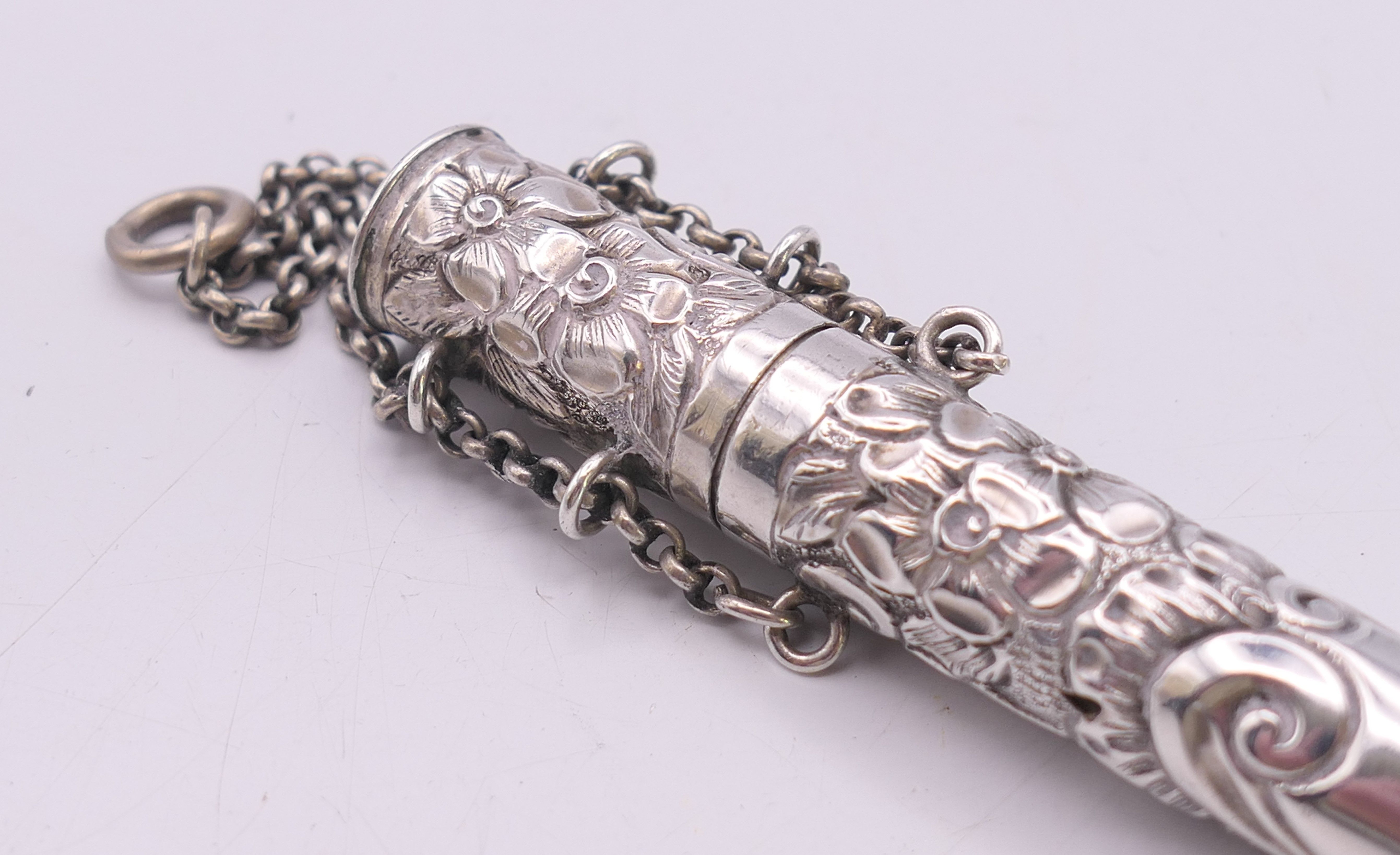 An embossed silver needle case. 14 cm high. - Image 2 of 5