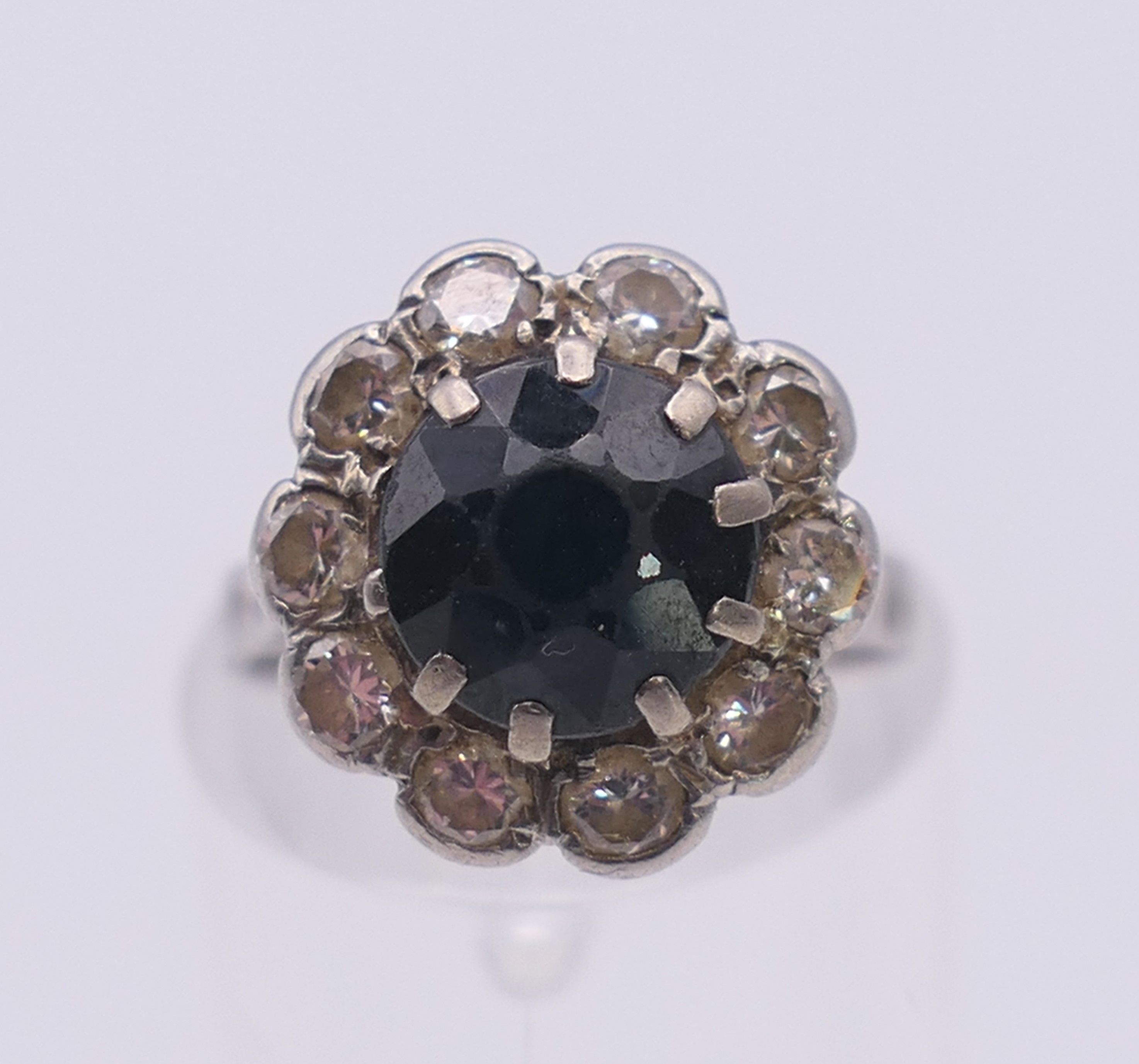 A platinum diamond and sapphire ring. Ring size H.