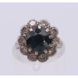 A platinum diamond and sapphire ring. Ring size H.