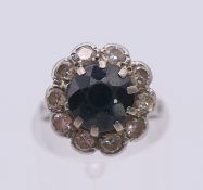 A platinum diamond and sapphire ring. Ring size H.