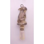 A mother-of-pearl and silver bunny rabbit rattle. 7.5 cm high.