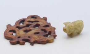 A jade pig and a jade pendant carving. Pig 2.5 cm high, pendant 9.5 x 8.5 cm.