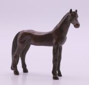 A bronze model of a horse. 7 cm high.