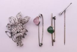 A trumpet tie pin, two 1920's pin brooches and a marcasite brooch. The former 6.5 cm high.