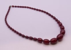A cherry amber graduated bead necklace. 64 cm long. 50.9 weight total weight.