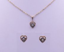 A 9 ct gold, diamond and pendant necklace and matching earrings. The pendant 1.7 cm high.