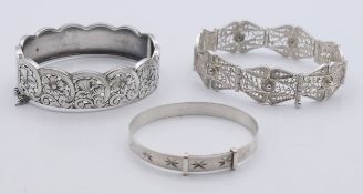 Three silver bracelets comprising of a child's bracelet,