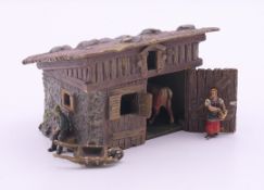 A cold painted bronze model of an Alpine farmhouse. 8 cm wide.