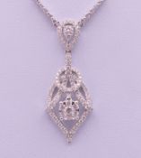 An 18 ct white gold diamond set pendant necklace. The pendant 3.5 cm high. The chain 42 cm long. 7.