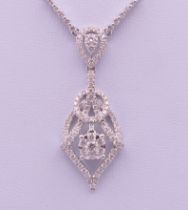 An 18 ct white gold diamond set pendant necklace. The pendant 3.5 cm high. The chain 42 cm long. 7.