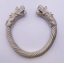 A Chinese silver plated dragon bangle. 9.5 cm exterior diameter.