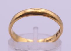 A 22 ct gold wedding band. Ring size L/M. 3 grammes.