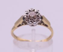An 18 ct gold diamond ring. The central stone spreading to approximately 0.25 of a carat.