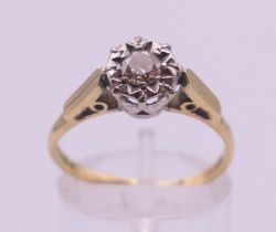 An 18 ct gold diamond ring. The central stone spreading to approximately 0.25 of a carat.
