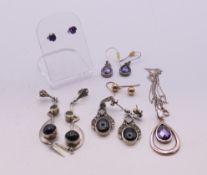 A quantity of various pairs of silver earrings and a silver pendant necklace. The pendant 3 cm high.