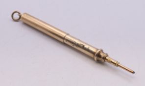 An unmarked yellow metal propelling pencil. 5.5 cm long when closed (excluding suspension loop).