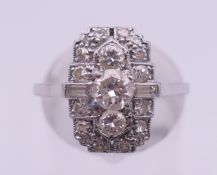 An unmarked Art Deco platinum and diamond ring, together with an insurance valuation dated 2011.