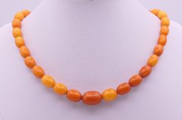 A string of amber beads. 40 cm long. 17.3 grammes total weight.